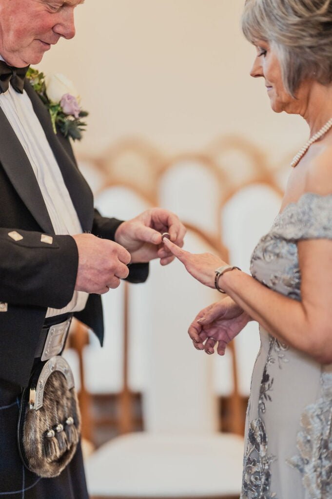 Bride and groom exchanging rings