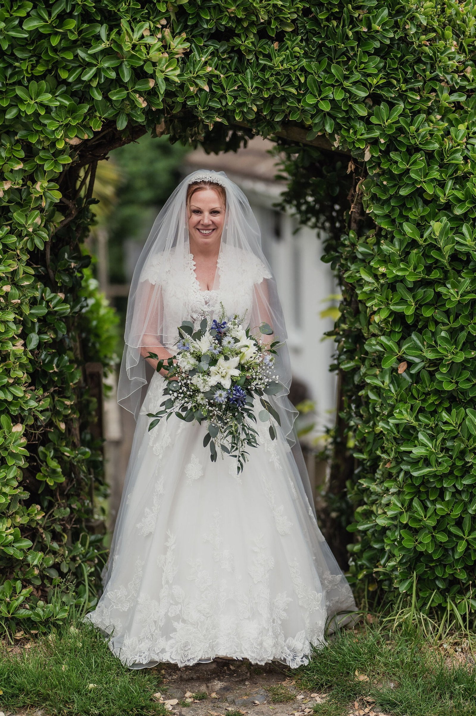 Bride in a leafy archway