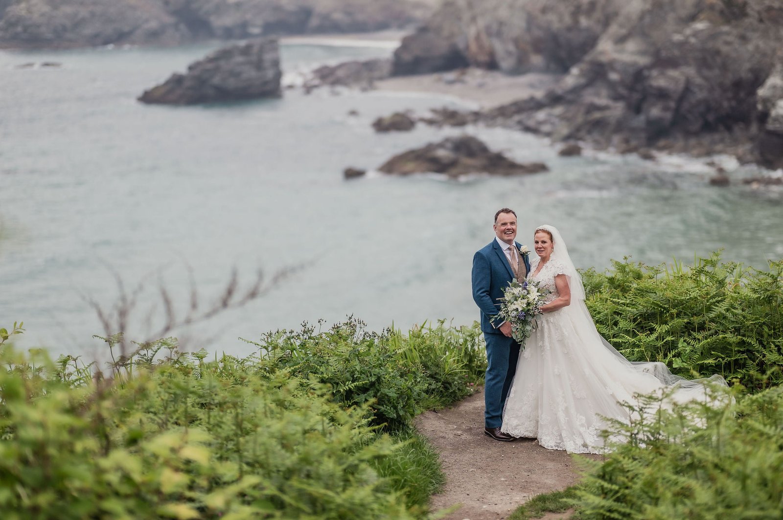 Bride and Groom on the cliff with sea in the background