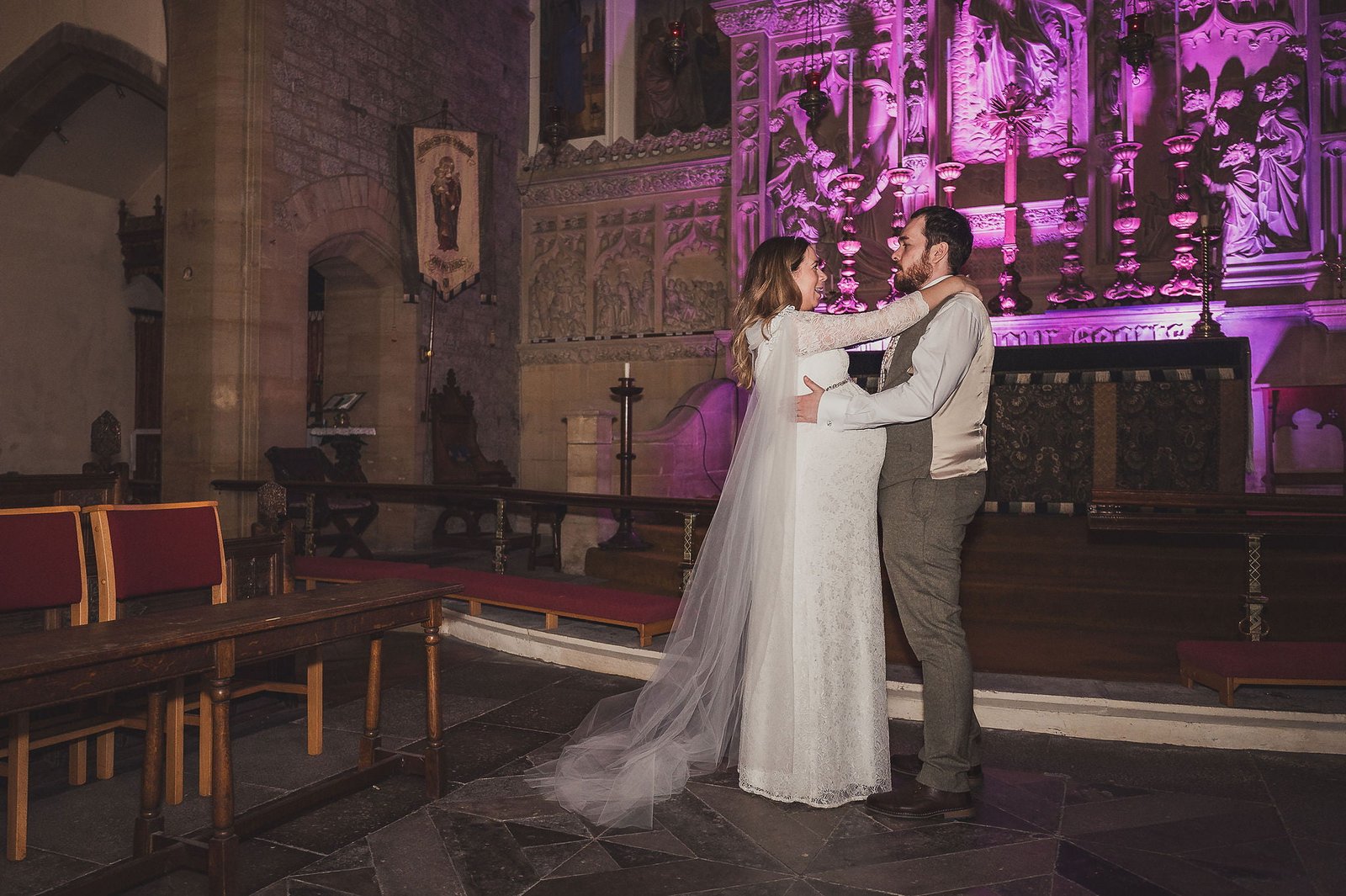 Bride and Groom in All Saints Church Falmouth with Purple lighting